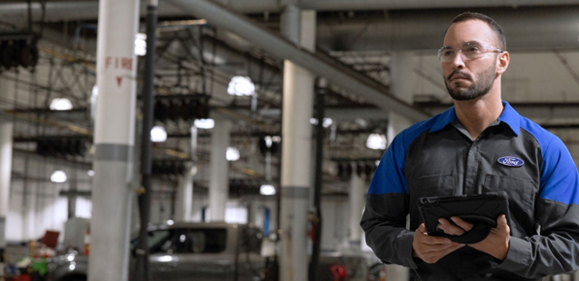 Ford Service Tehnician holding a tablet